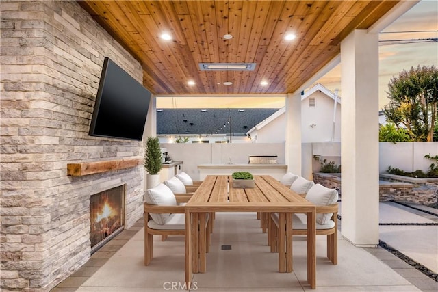 11385 Baskerville Rd, Rossmoor, CA 90720 - fenced backyard with a warm lit fireplace, a patio, and outdoor dining area