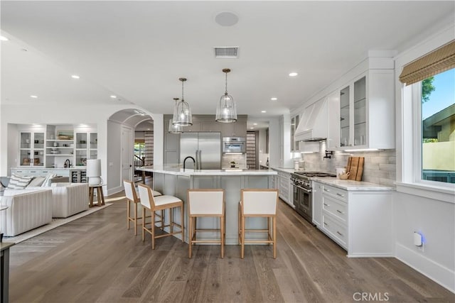 11385 Baskerville Rd, Rossmoor, CA 90720 - kitchen featuring high end appliances, custom exhaust hood, light countertops, white cabinetry, and dark wood-style floors