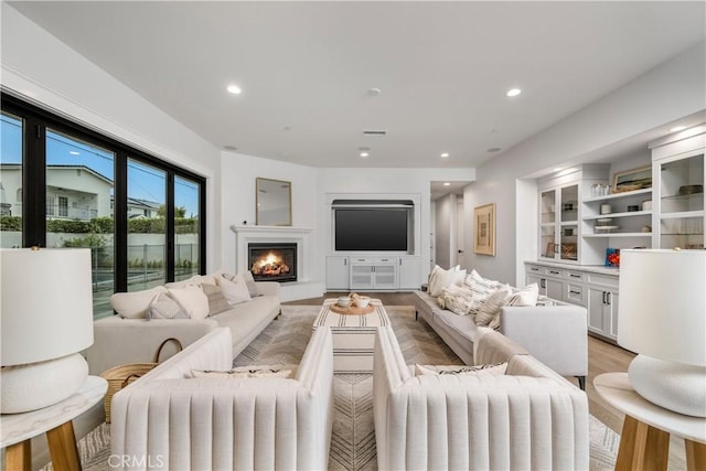 11385 Baskerville Rd, Rossmoor, CA 90720 - living area with light wood finished floors, recessed lighting, and a warm lit fireplace