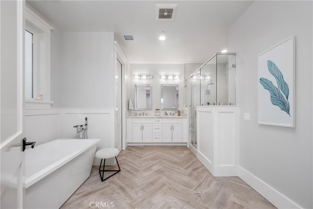 11385 Baskerville Rd, Rossmoor, CA 90720 - bathroom featuring a soaking tub, double vanity, a stall shower, and wainscoting