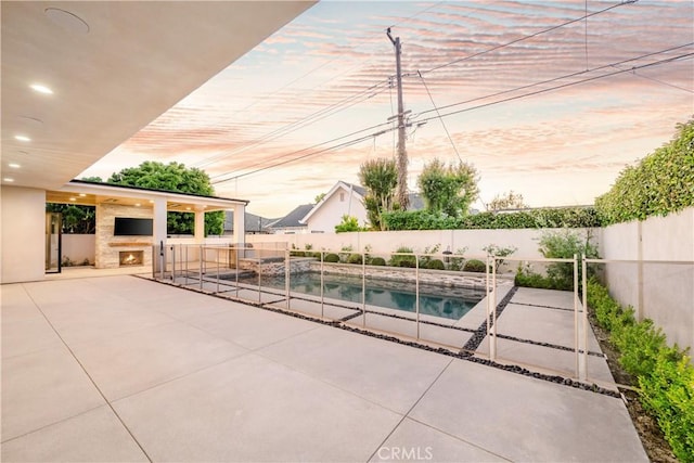 11385 Baskerville Rd, Rossmoor, CA 90720 - view of pool featuring a patio area, a fenced backyard, a pool with connected hot tub, and a lit fireplace