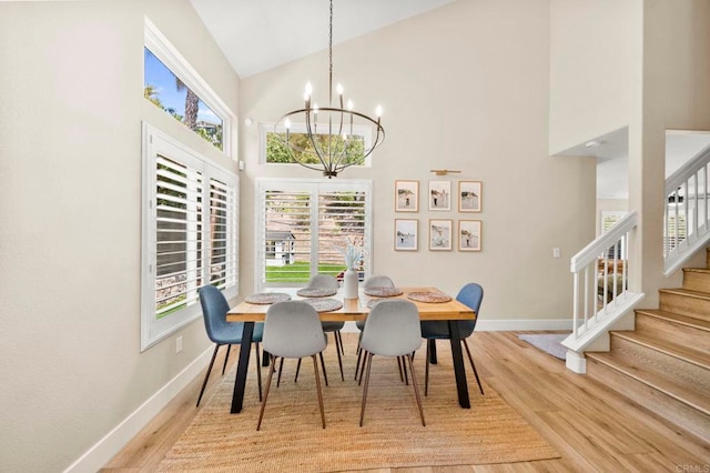 641 Hillhaven Dr, San Marcos, CA 92078 - dining area with high vaulted ceiling, wood finished floors, a chandelier, and stairway