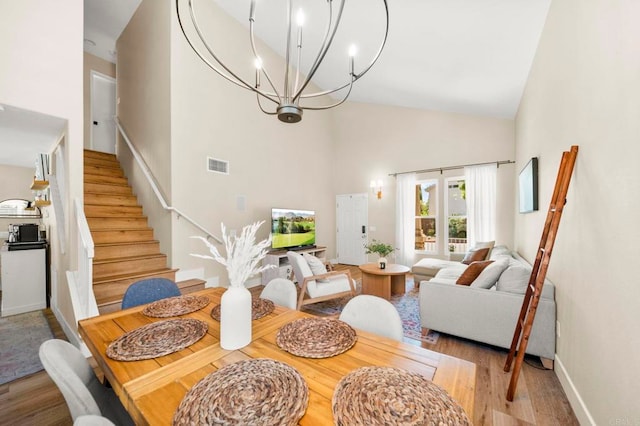 641 Hillhaven Dr, San Marcos, CA 92078 - dining area with high vaulted ceiling, stairway, a chandelier, and wood finished floors