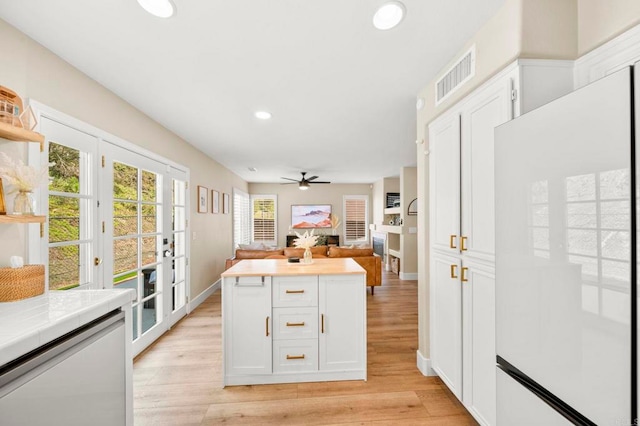 641 Hillhaven Dr, San Marcos, CA 92078 - kitchen with freestanding refrigerator, a ceiling fan, white cabinets, light wood finished floors, and recessed lighting