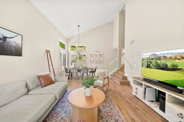 641 Hillhaven Dr, San Marcos, CA 92078 - living area with a chandelier, high vaulted ceiling, light wood-style flooring, and stairway