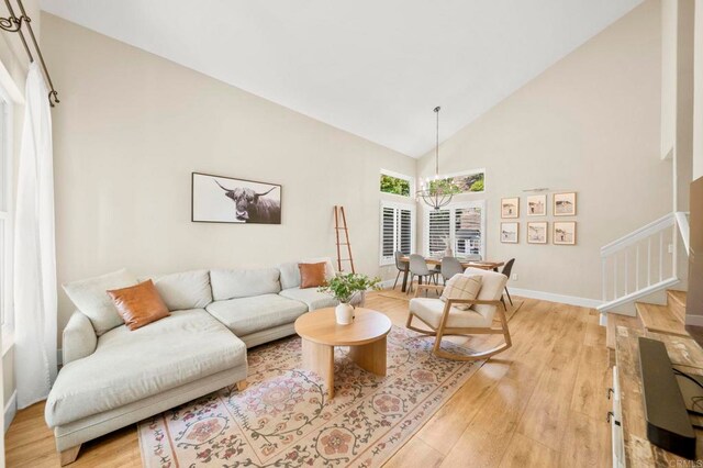 641 Hillhaven Dr, San Marcos, CA 92078 - living area featuring light wood finished floors, high vaulted ceiling, and stairway