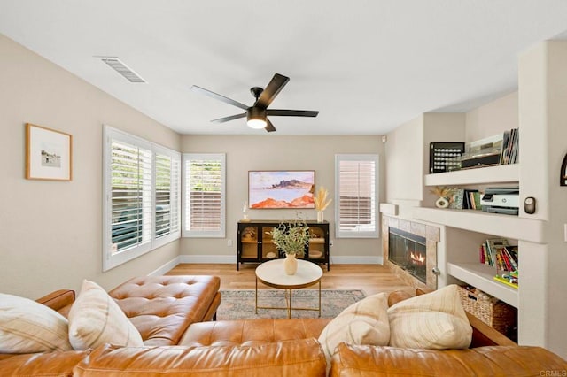 641 Hillhaven Dr, San Marcos, CA 92078 - living room with a ceiling fan, a tiled fireplace, plenty of natural light, and wood finished floors