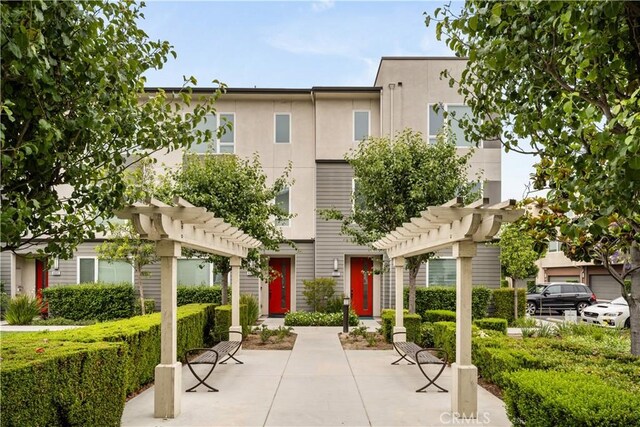 10648 Paramount Blvd, Downey, CA 90241 - view of property with a pergola and stucco siding