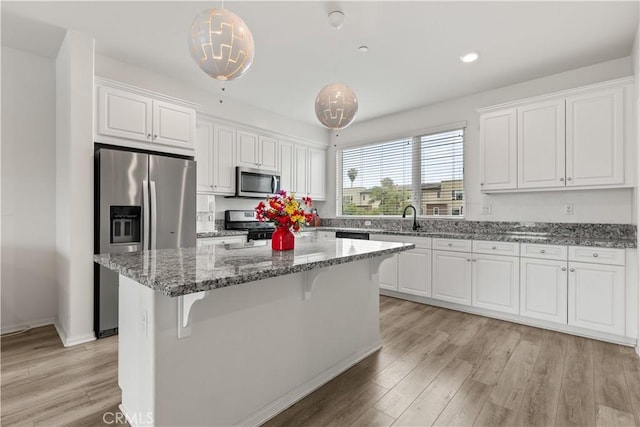 10648 Paramount Blvd, Downey, CA 90241 - kitchen with appliances with stainless steel finishes, white cabinets, a center island, and recessed lighting
