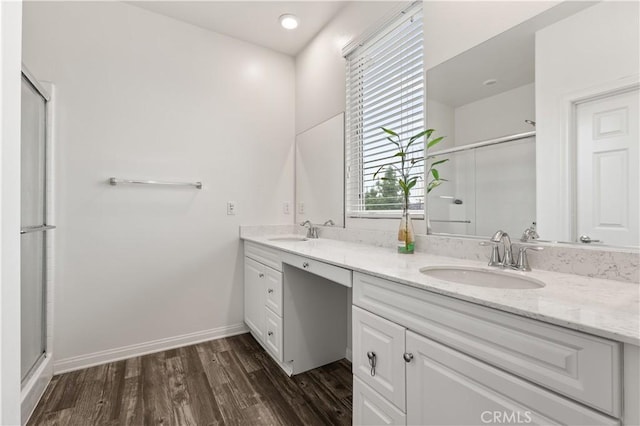 10648 Paramount Blvd, Downey, CA 90241 - full bathroom with double vanity, a shower with door, and wood finished floors