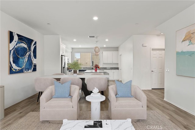 10648 Paramount Blvd, Downey, CA 90241 - living room featuring light wood finished floors and recessed lighting
