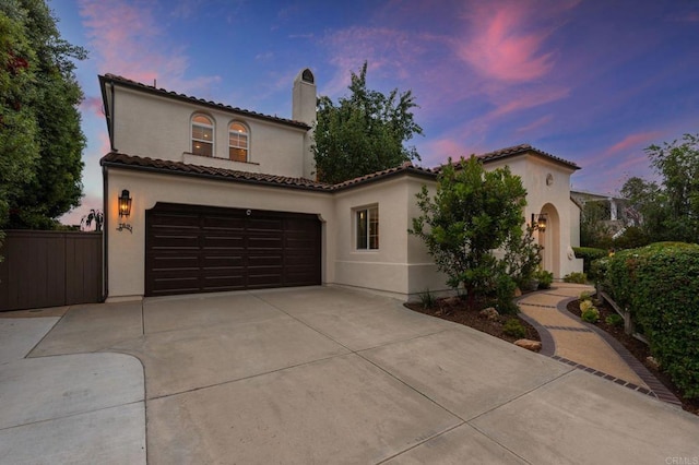 7691 Circulo Sequoia, Carlsbad, CA 92009 - mediterranean / spanish home with concrete driveway, stucco siding, a chimney, and a tiled roof