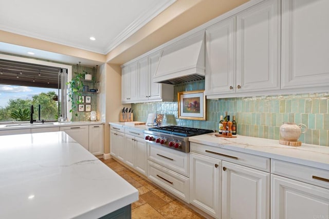 7691 Circulo Sequoia, Carlsbad, CA 92009 - kitchen with stainless steel gas cooktop, premium range hood, ornamental molding, tasteful backsplash, and white cabinetry