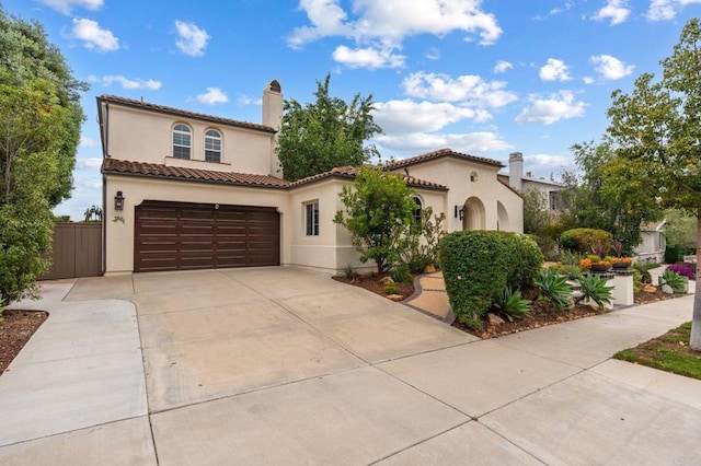 7691 Circulo Sequoia, Carlsbad, CA 92009 - mediterranean / spanish-style home with concrete driveway, stucco siding, a chimney, a tiled roof, and a garage