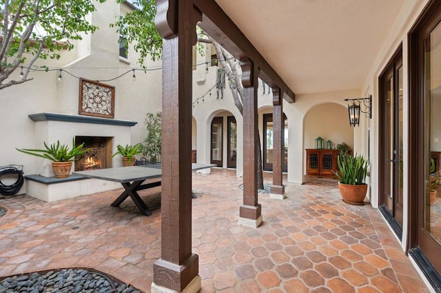 7691 Circulo Sequoia, Carlsbad, CA 92009 - view of patio / terrace featuring a lit fireplace and french doors