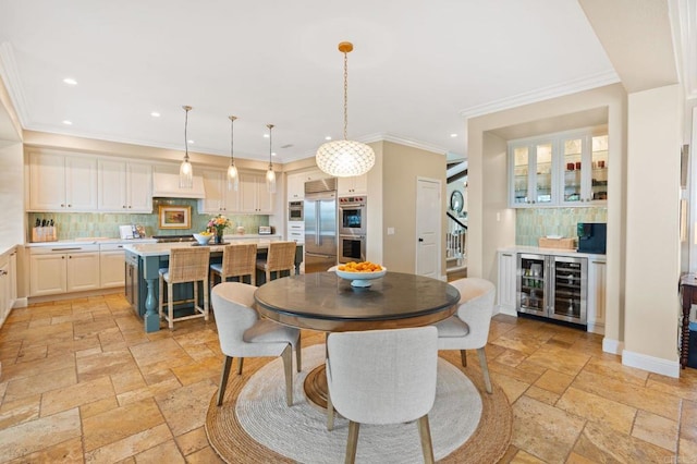 7691 Circulo Sequoia, Carlsbad, CA 92009 - dining space featuring stone tile floors, beverage cooler, recessed lighting, and crown molding