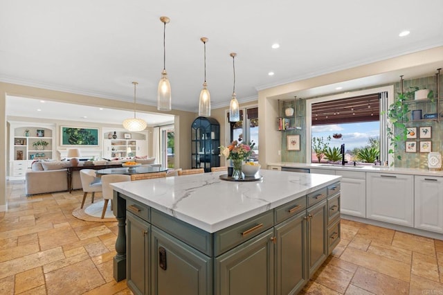 7691 Circulo Sequoia, Carlsbad, CA 92009 - kitchen featuring stone tile floors, white cabinetry, crown molding, a center island, and recessed lighting