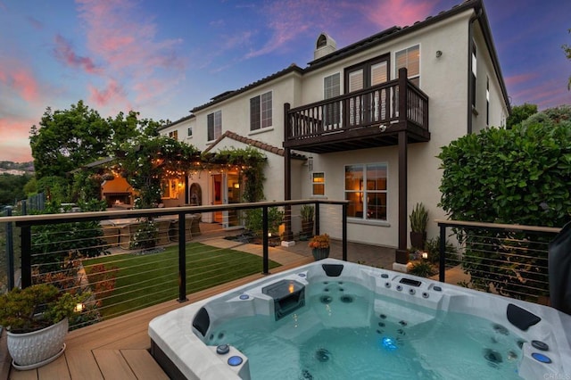 7691 Circulo Sequoia, Carlsbad, CA 92009 - back of house at dusk featuring stucco siding, a balcony, a chimney, and a deck