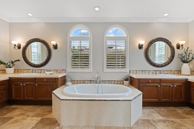 7691 Circulo Sequoia, Carlsbad, CA 92009 - bathroom featuring two vanities, a garden tub, stone tile floors, crown molding, and recessed lighting
