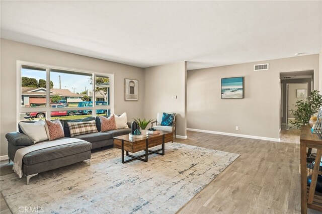 2406 S Pacific Ave, Santa Ana, CA 92704 - living area with light wood finished floors and baseboards