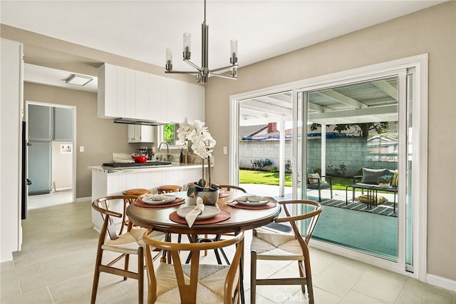 2406 S Pacific Ave, Santa Ana, CA 92704 - dining area with a chandelier and light tile patterned flooring