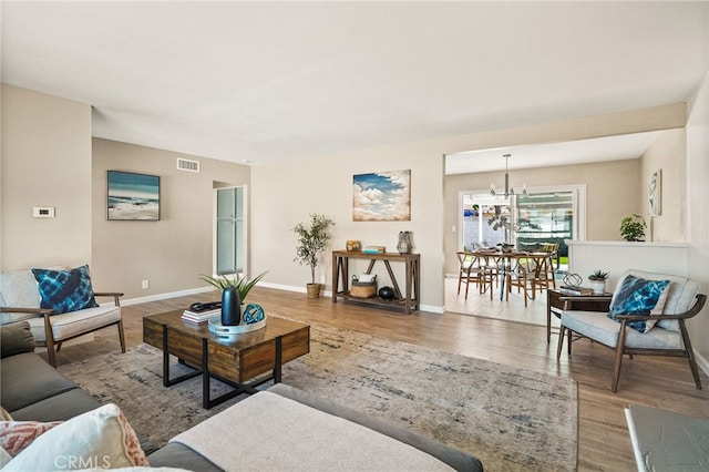 2406 S Pacific Ave, Santa Ana, CA 92704 - living room featuring wood finished floors and a chandelier