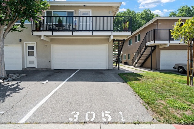3051 Knollwood Ave, La Verne, CA 91750 - view of property featuring stucco siding, stairway, a garage, and a balcony