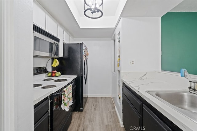 3051 Knollwood Ave, La Verne, CA 91750 - kitchen featuring stainless steel microwave, electric range, light wood-style floors, white cabinetry, and dark cabinets