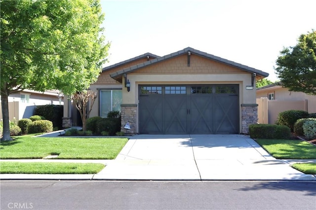 1573 Maple Valley St, Manteca, CA 95336 - craftsman inspired home with driveway, an attached garage, stone siding, and a front lawn