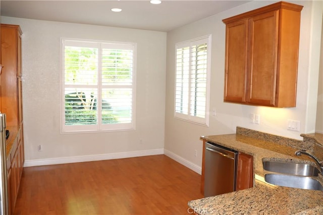 1573 Maple Valley St, Manteca, CA 95336 - kitchen with dishwasher, wood finished floors, plenty of natural light, brown cabinets, and recessed lighting