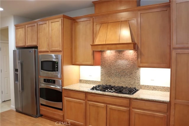 1573 Maple Valley St, Manteca, CA 95336 - kitchen featuring appliances with stainless steel finishes, custom exhaust hood, backsplash, light stone counters, and recessed lighting