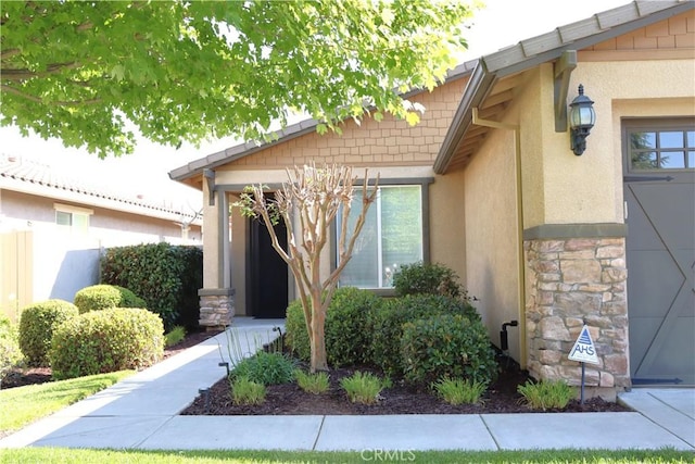 1573 Maple Valley St, Manteca, CA 95336 - doorway to property featuring stucco siding and stone siding