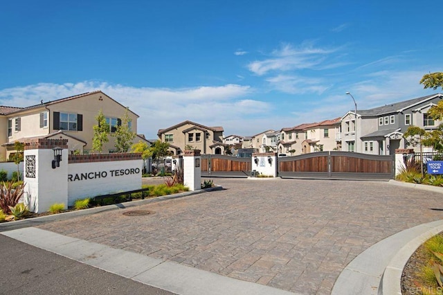 140 Unity Ln, San Marcos, CA 92078 - view of street with a residential view, a gate, a gated entry, curbs, and street lighting