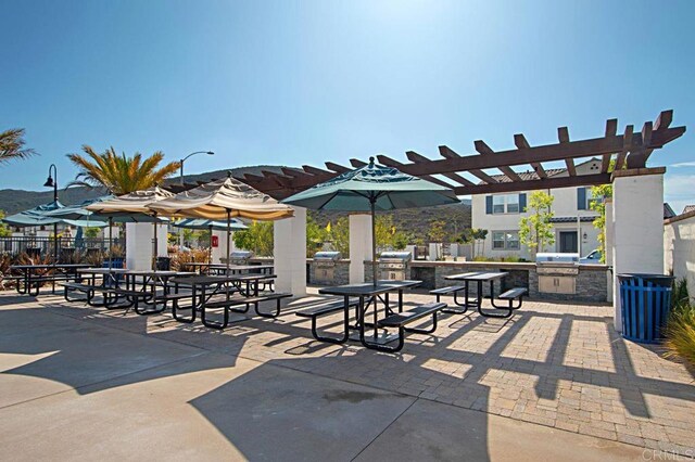 140 Unity Ln, San Marcos, CA 92078 - surrounding community with exterior kitchen, a patio, and a pergola