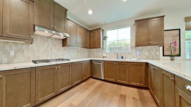 140 Unity Ln, San Marcos, CA 92078 - kitchen featuring appliances with stainless steel finishes, under cabinet range hood, light wood finished floors, backsplash, and recessed lighting