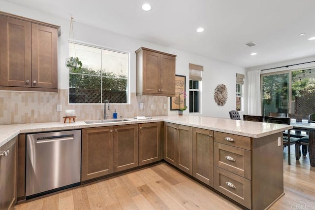 140 Unity Ln, San Marcos, CA 92078 - kitchen with stainless steel dishwasher, light wood-type flooring, a peninsula, recessed lighting, and decorative backsplash