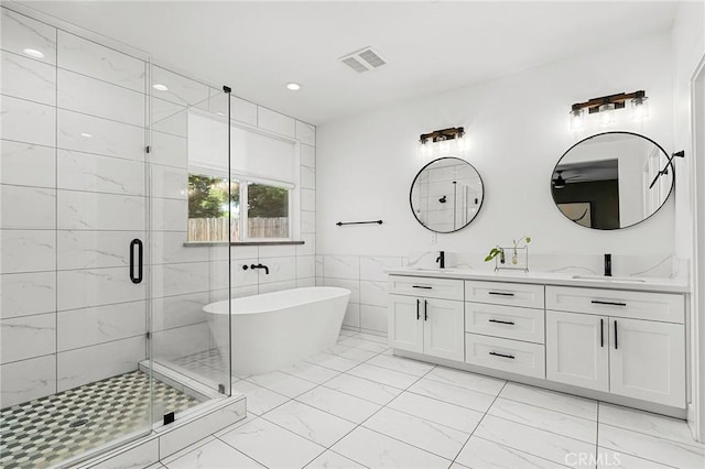 2213 De Mille Rd, Paradise, CA 95969 - bathroom with marble look tile flooring, a soaking tub, double vanity, a shower stall, and tile walls