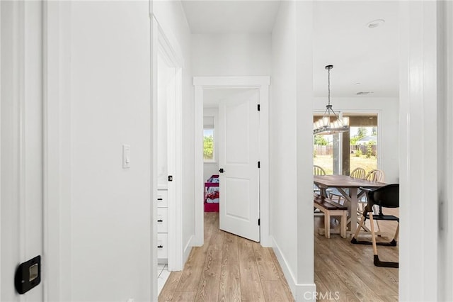 2213 De Mille Rd, Paradise, CA 95969 - hallway featuring light wood finished floors and a chandelier