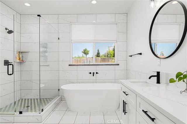 2213 De Mille Rd, Paradise, CA 95969 - bathroom with marble look tile flooring, a freestanding tub, a shower stall, vanity, and recessed lighting