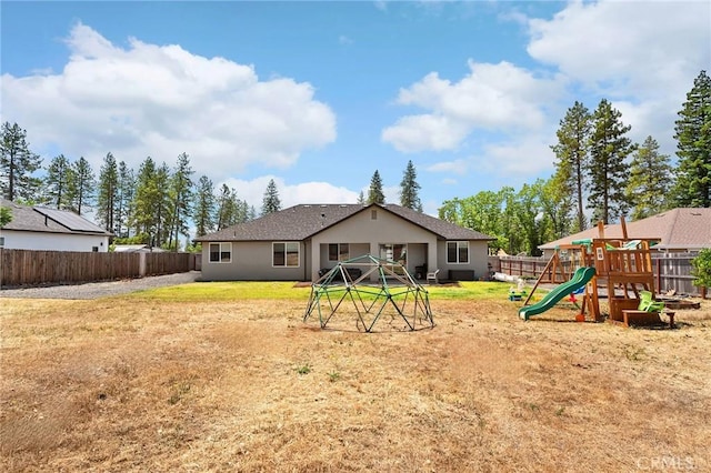 2213 De Mille Rd, Paradise, CA 95969 - back of house with a playground, a fenced backyard, and stucco siding