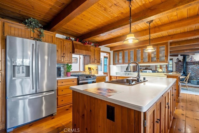 2645 Apple Ln, Julian, CA 92036 - kitchen featuring stainless steel appliances, wood-type flooring, brown cabinetry, a wood ceiling with exposed beams, and a kitchen island with sink