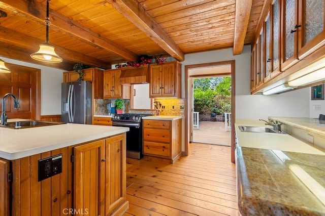2645 Apple Ln, Julian, CA 92036 - kitchen with stainless steel appliances, a wood ceiling with exposed beams, light wood finished floors, brown cabinetry, and light countertops