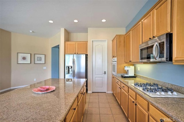82756 Burnette Dr, Indio, CA 92201 - kitchen featuring appliances with stainless steel finishes, light stone counters, light tile patterned floors, and recessed lighting