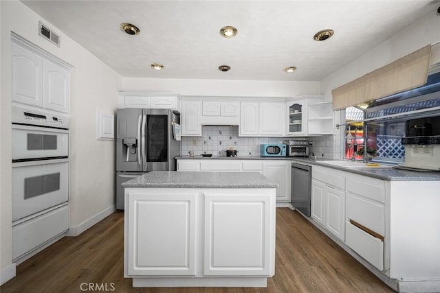 4481 Larwin Ave, Cypress, CA 90630 - kitchen featuring stainless steel appliances, white cabinets, backsplash, and a kitchen island