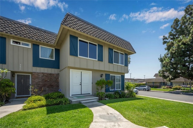 4481 Larwin Ave, Cypress, CA 90630 - multi unit property with roof with shingles, a front yard, mansard roof, brick siding, and board and batten siding