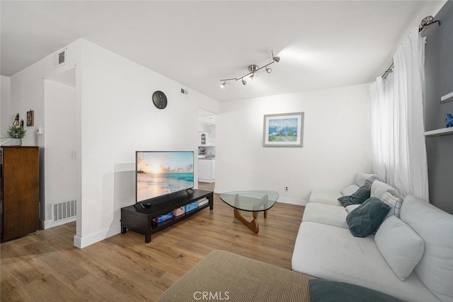 4481 Larwin Ave, Cypress, CA 90630 - living area featuring wood finished floors and rail lighting