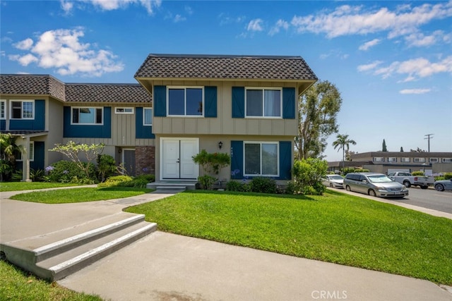 4481 Larwin Ave, Cypress, CA 90630 - townhome / multi-family property featuring a front yard, board and batten siding, and mansard roof