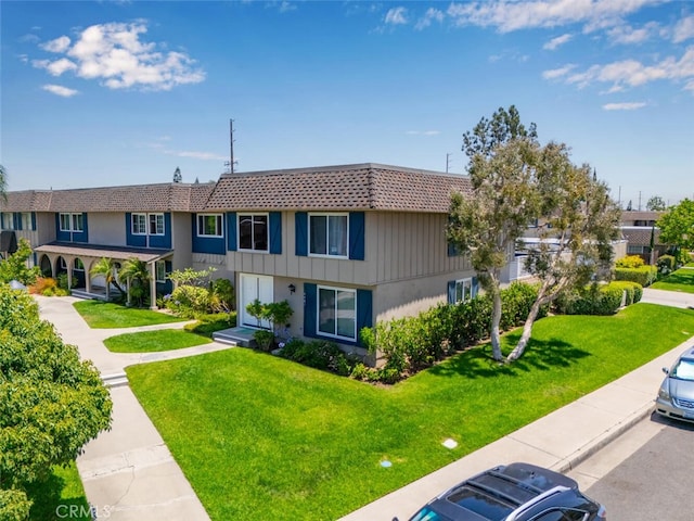 4481 Larwin Ave, Cypress, CA 90630 - townhome / multi-family property with a front yard, mansard roof, and uncovered parking