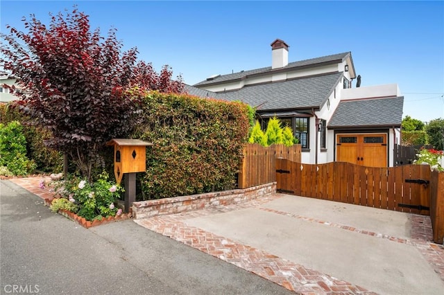 615 Seaview St, Laguna Beach, CA 92651 - view of front of property with a shingled roof, a fenced front yard, a gate, and an attached garage