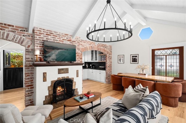 615 Seaview St, Laguna Beach, CA 92651 - living area featuring light wood-style floors, a brick fireplace, and a chandelier